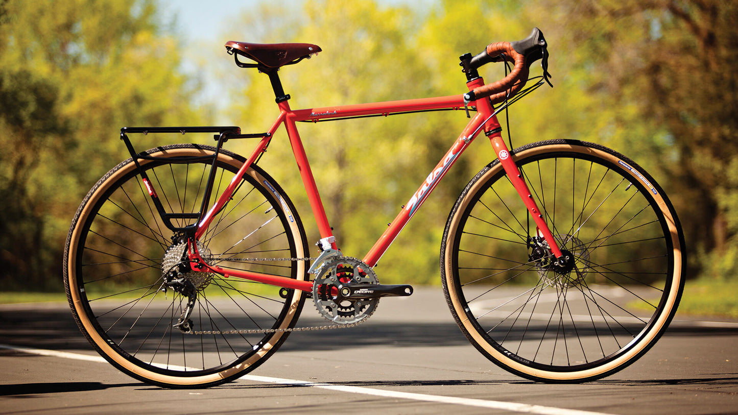 Salsa Marrakesh Deore bike with rear rack orange color side view outside