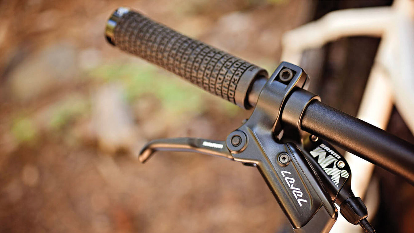 Salsa Mukluk NX1 SUS bike white and black color grip, brake, and shift lever area focus