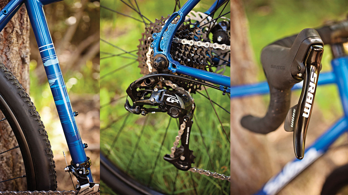 Close-up of a blue bicycle with detailed components on a natural background