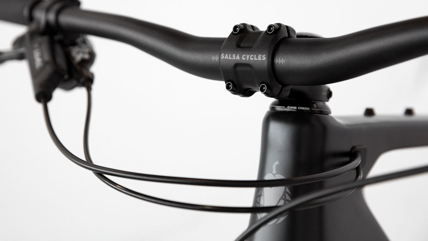 Close-up of a black bicycle handlebar with Salsa Cycles branding on a white background