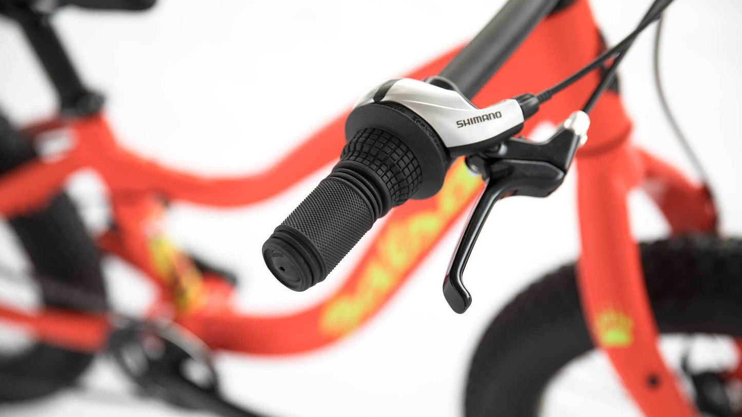 Close-up of bicycle handlebar with Shimano components on a blurred background
