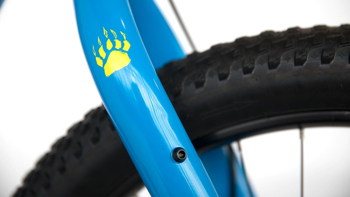 Close-up of a blue bicycle frame with a yellow paw print design on a white background