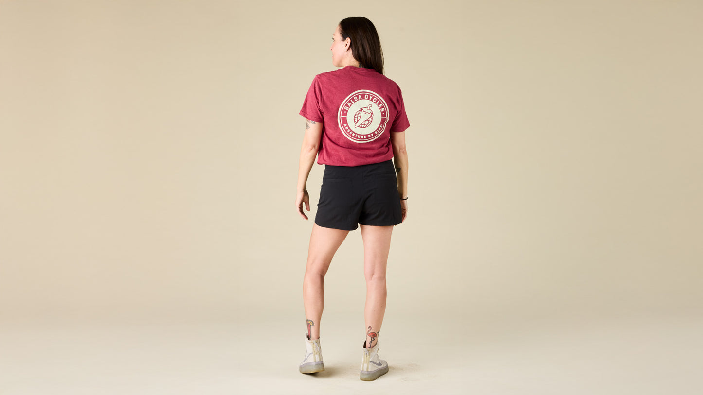 Female model faces the back while wearing the Salsa red logo tee