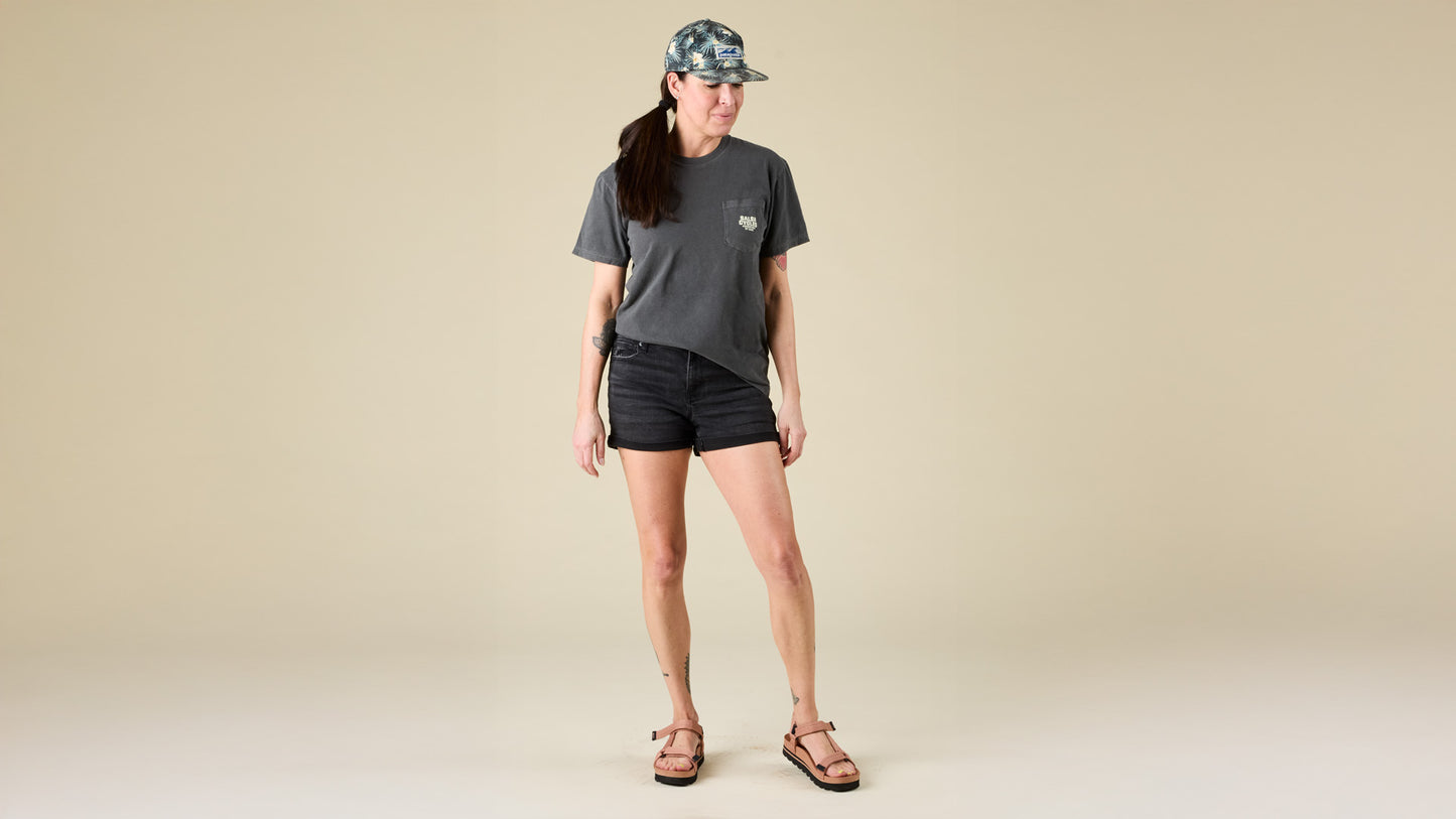 Female model faces the front while wearing the Salsa pocket t-shirt in charcoal