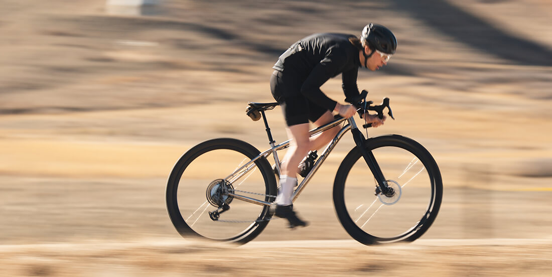 Person riding a bicycle at high speed on a blurred road