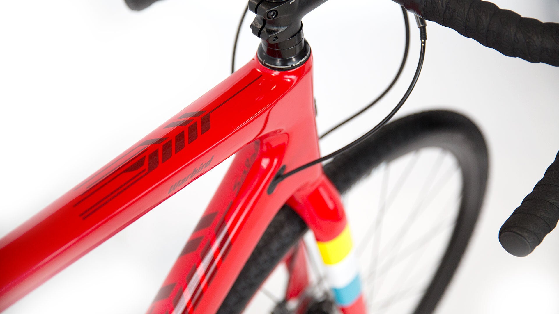 Close-up of a red bicycle frame with a white background