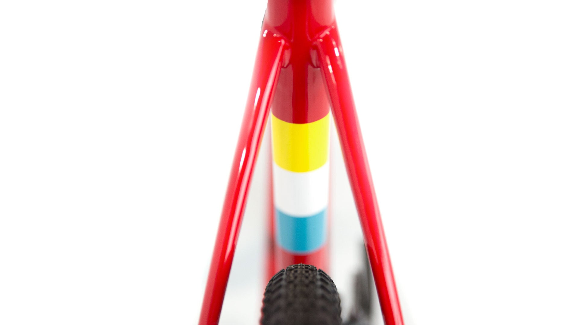 Close-up of a red bicycle frame with colorful accents on a white background