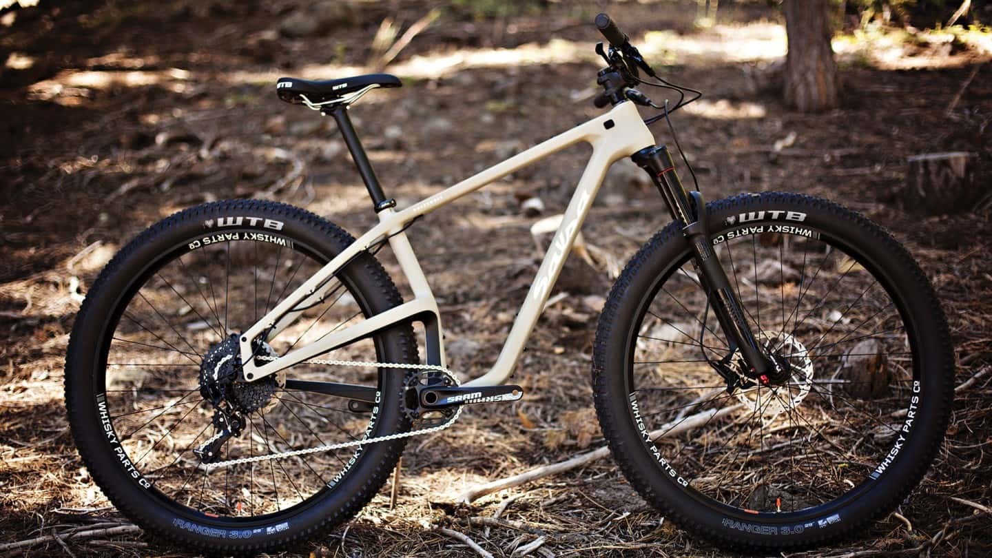 Salsa Woodsmoke Carbon GX1 29 Plus bike tan color side view in forest