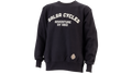A black crewneck sweatshirt with 'SALSA CYCLES ADVENTURE BY BIKE' printed in white arched text on the chest, and a small circular patch near the lower left hem, shown on a plain white background.