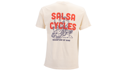 A cream-colored short-sleeve t-shirt shown from the back, featuring a large graphic print with the words 'SALSA CYCLES' in bold red letters and a blue line-art illustration of a person riding a bicycle. Smaller text below reads 'ADVENTURE BY BIKE'.