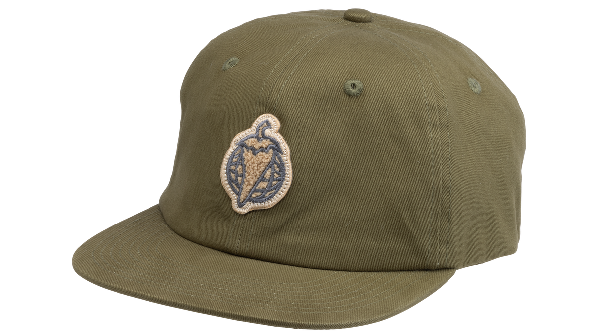 An olive green flat-brim baseball cap featuring a circular embroidered patch on the front with a pepper