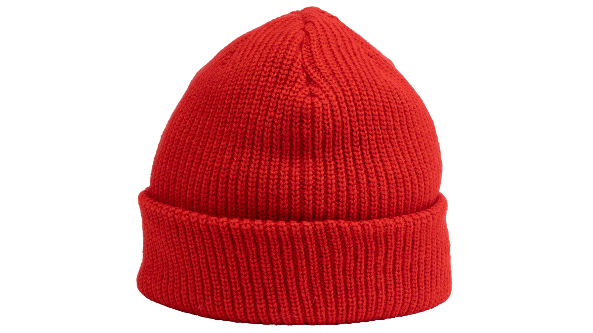 A bright red ribbed knit beanie hat with a folded cuff, shown against a plain white background.