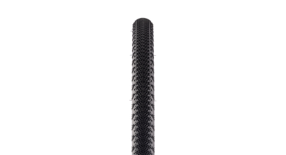A close-up vertical view of a black bicycle tire tread against a solid white background.