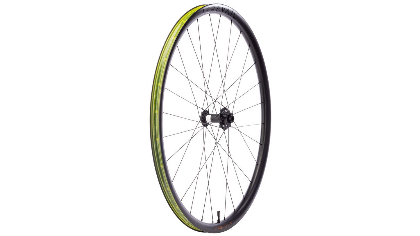 A single bicycle wheel with a black rim, black hub, and thin silver spokes, featuring a yellow-green tubeless tape strip along the outer edge, shown against a plain white background.