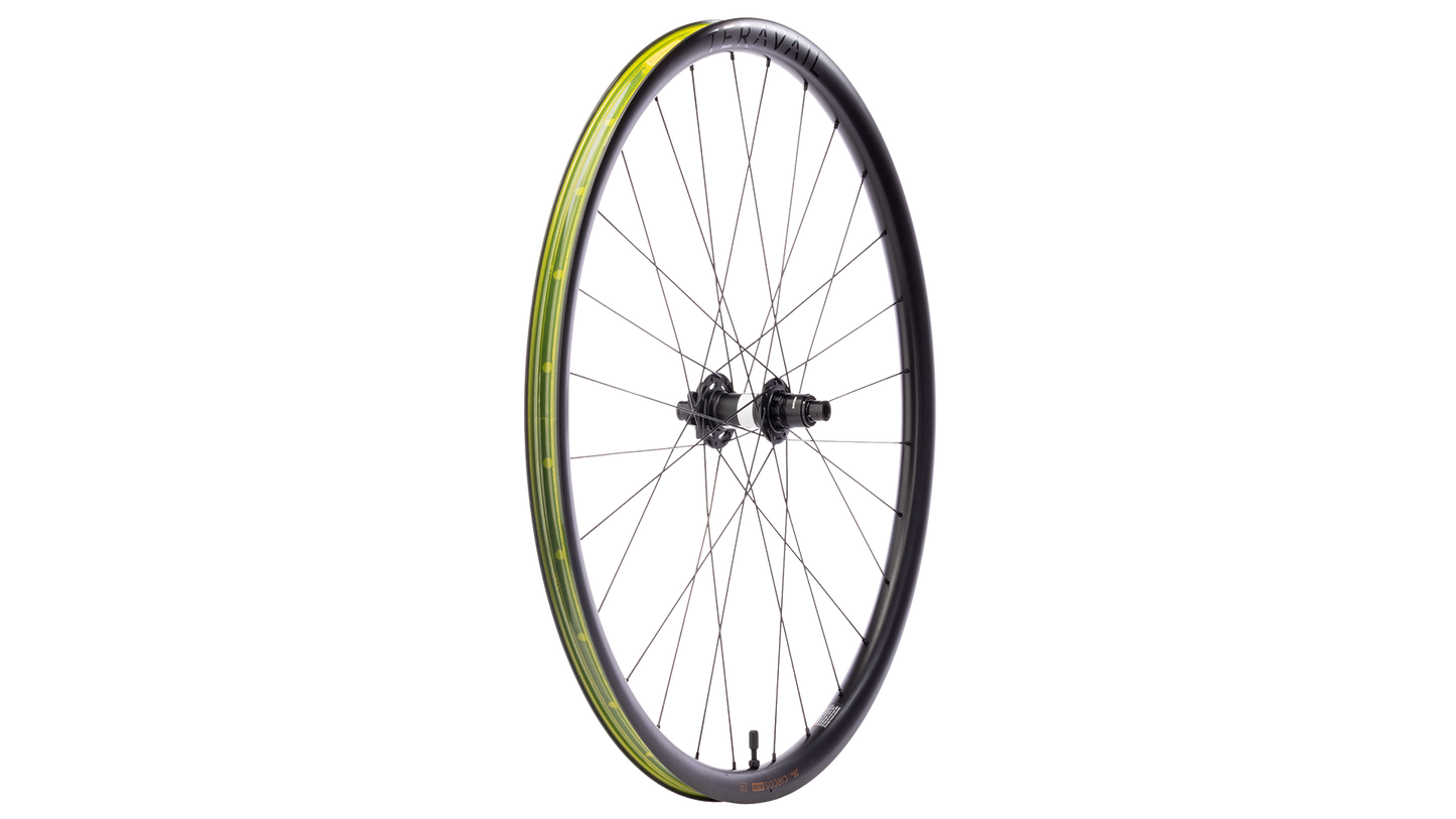 A single bicycle wheel with a black rim, black hub, and yellow-green tubeless tape, shown against a plain white background.